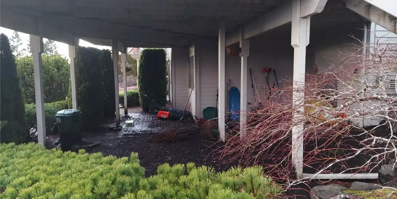 Before: Muddy backyard patio with drainage problems in Longmont