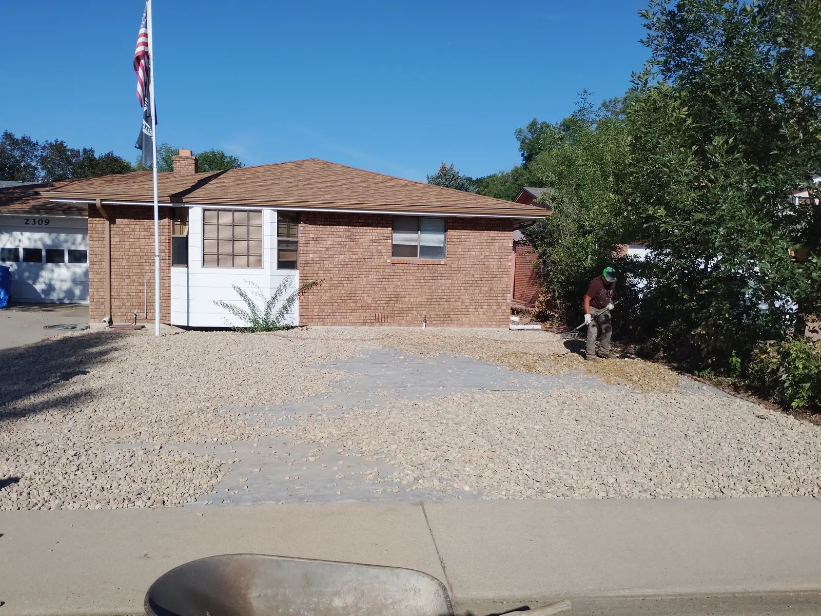 Rock delivery: utility trailer loaded with 12 tons of tan-to-brown river rock