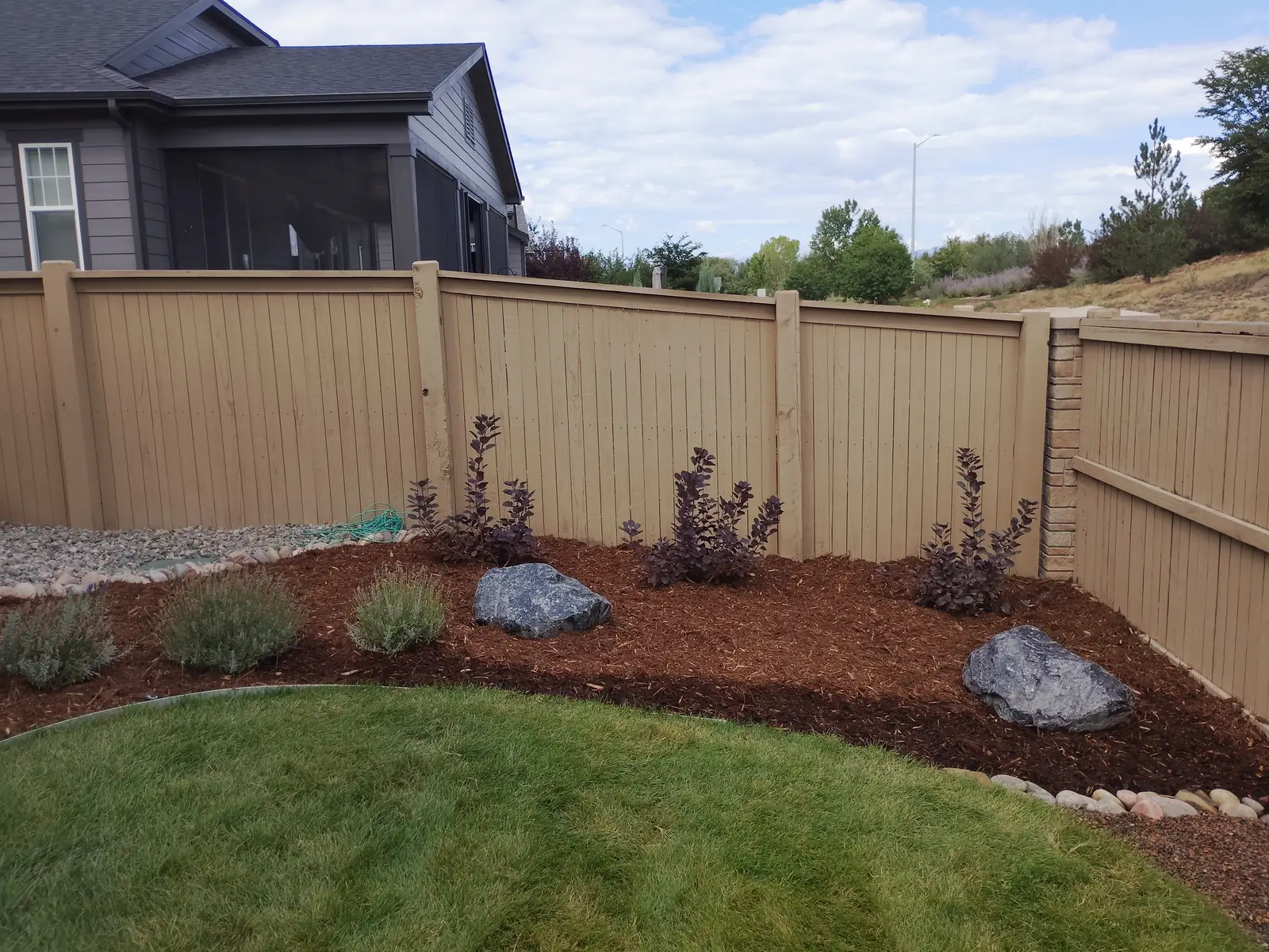 Perennial plant bed filling in alongside the flagstone stepping path