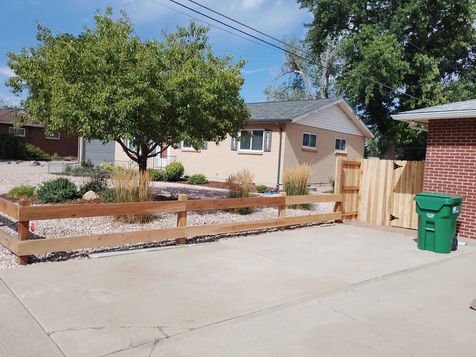 Cedar fence and split-rail section at the front of the property