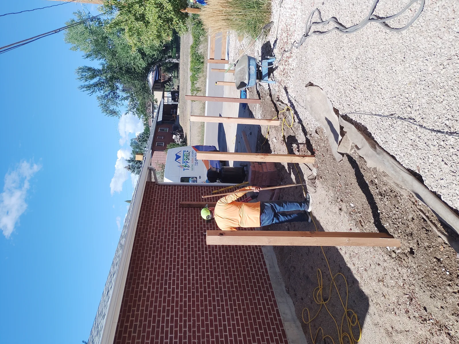 Cedar fence posts being set during installation
